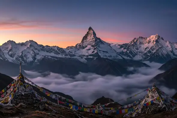 Himalayan Sunrise with Prayer Flags and Snow-Covered Peaks