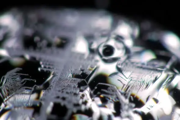 Extreme Macro Shot of Silver Metallic Surface with Light Reflections