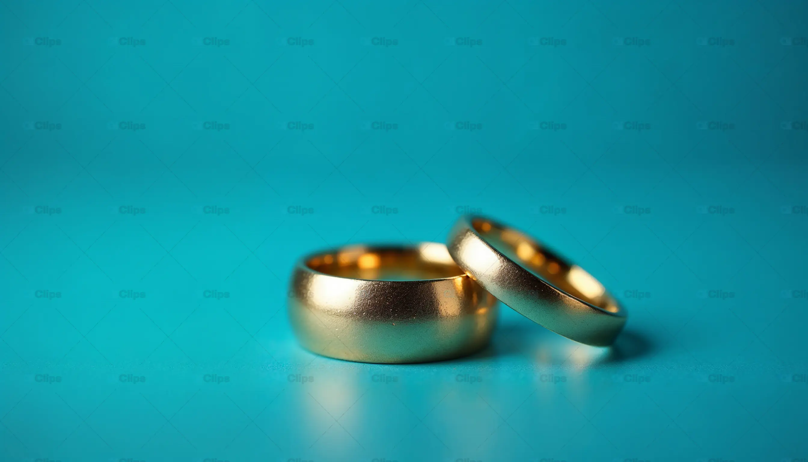 Gold Wedding Rings on Blue Background