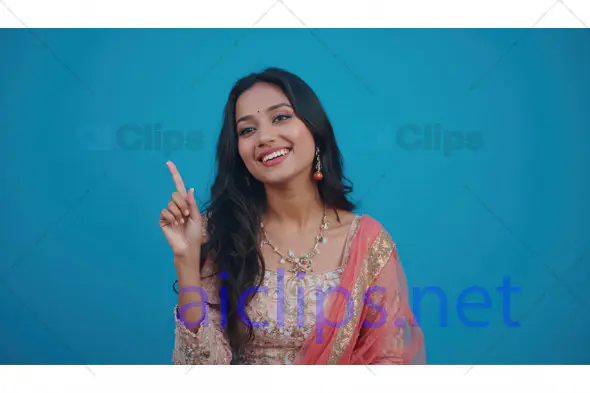 Smiling Woman in Traditional Attire Pointing Up