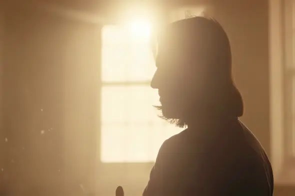 Atmospheric Silhouette Backlit by Golden Window Light