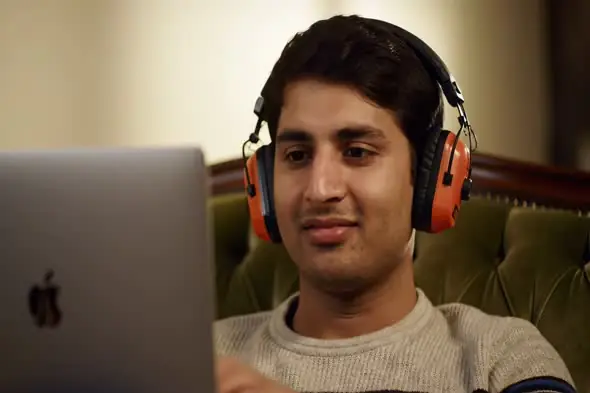 Focused Laptop User with Noise-Cancelling Headphones