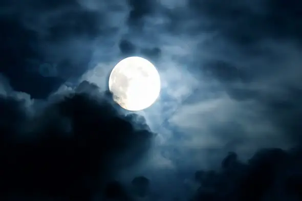 Full Moon Shining Through Clouds at Night