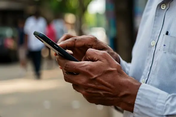Senior Hands Navigating Smartphone