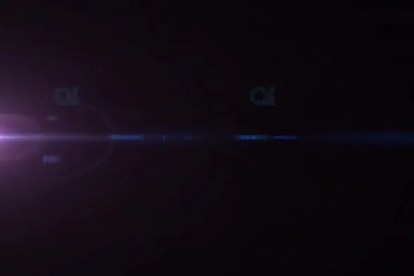 Subtle Purple and Blue Light Flare Across Dark Background