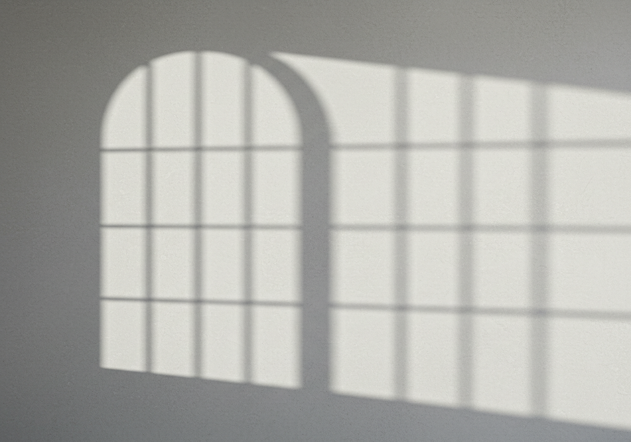 Arched Window Shadow on White Wall