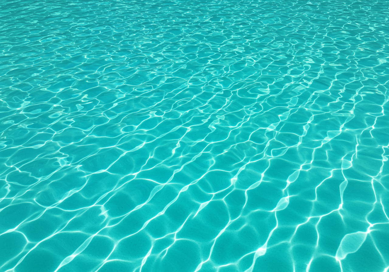 Clear Blue Pool Water with Sun Reflections