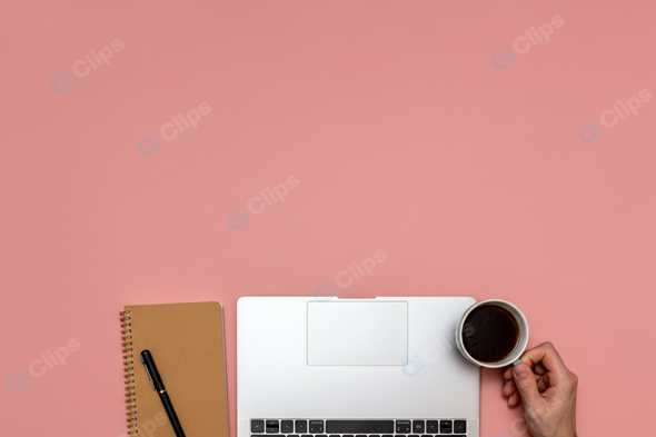 Laptop with Coffee and Notebook on Pink Background