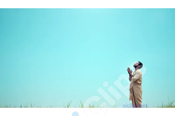 Man Praying in Nature Against a Vast Blue Sky