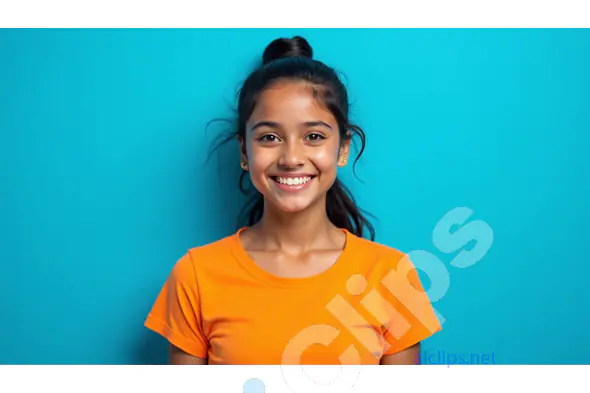 Smiling Young Girl in Bright Orange T-Shirt Against Blue Background